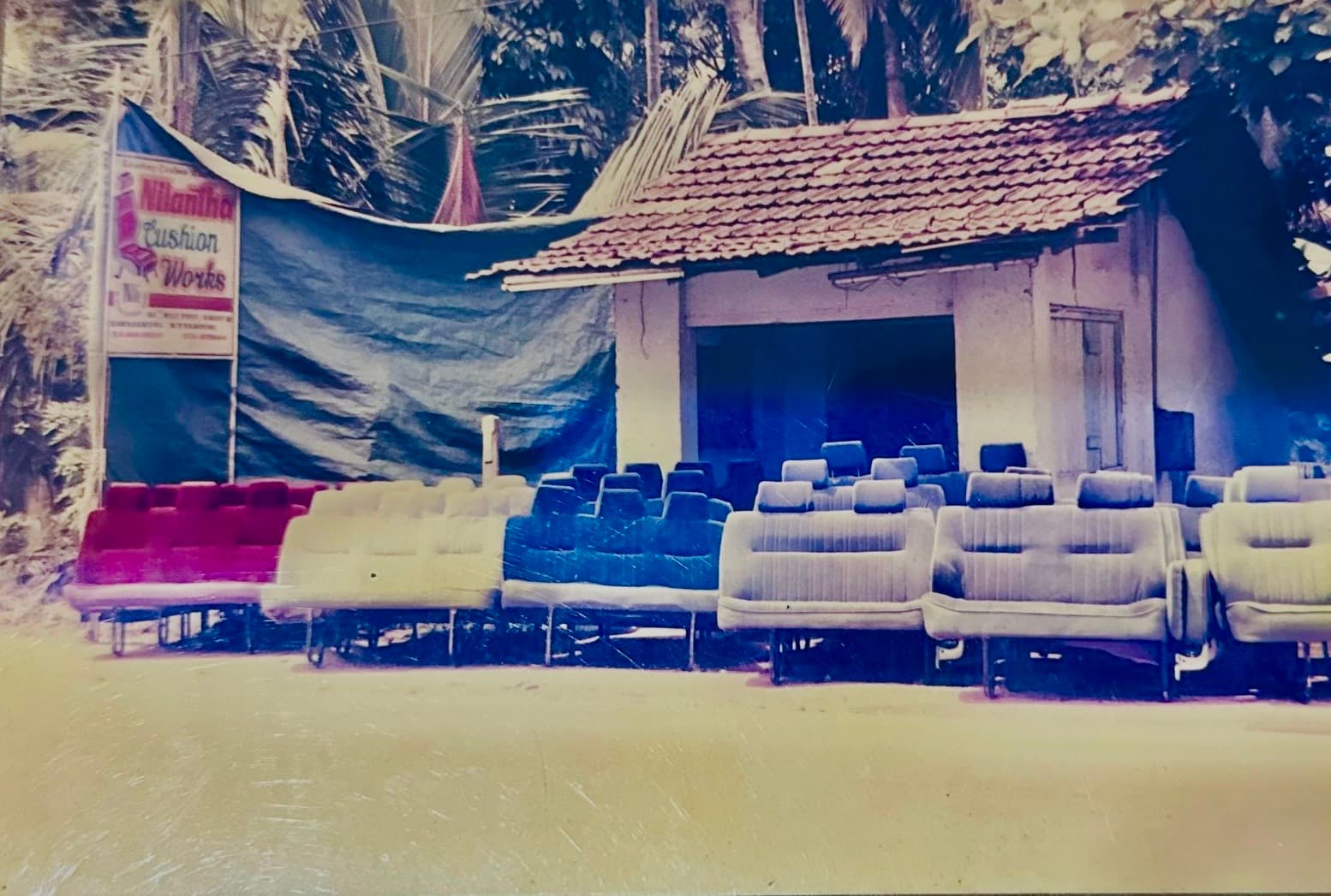 The original Nilantha Cushion Works with hand-built seat sets lined up outside the first roadside workshop